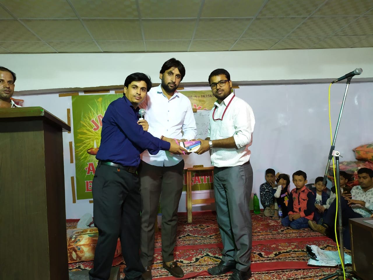 A clear jar half-full of coins with a label that says 'SAVINGS'.